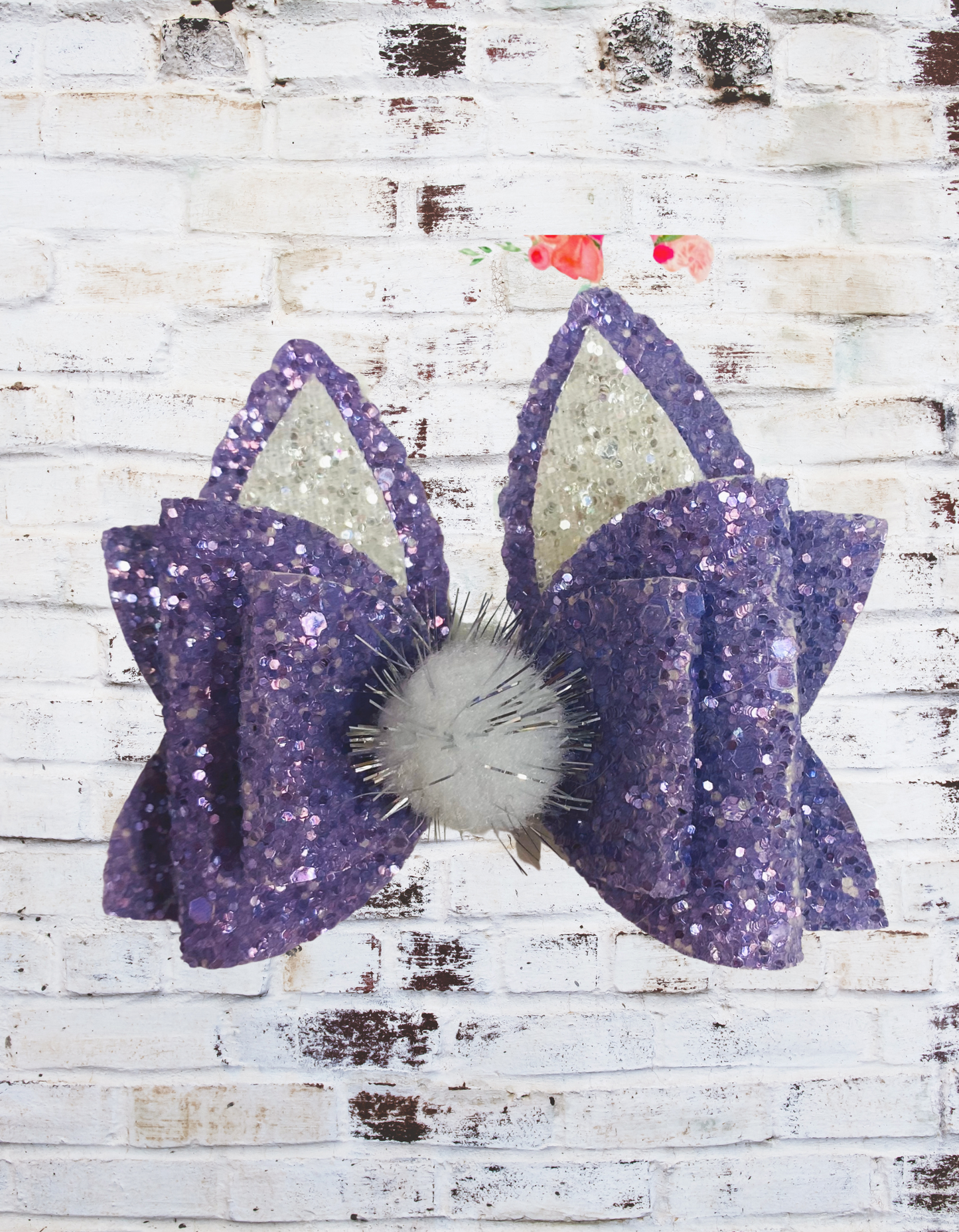 A purple glitter bunny hair bow with a sparkling finish, securely attached to an aligator clip, perfect for Easter outfits and festive hairstyles